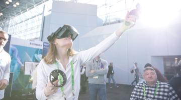 An individual sampling new technology at Retail's Big Show.