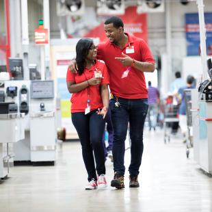 Two employees at BJ's walking and smiling