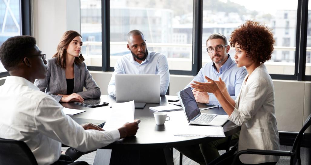 A corporate meeting amongst diverse individuals.