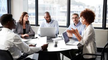 A corporate meeting amongst diverse individuals.
