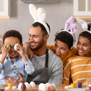 Family painting Easter eggs.