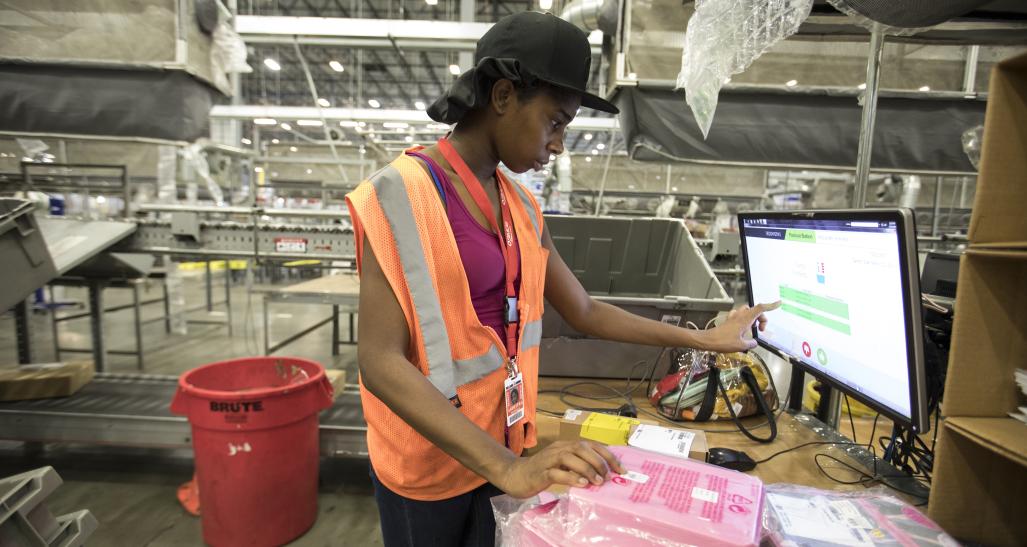 Employee at Williams Sonoma warehouse working on computer