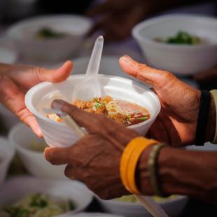 Two hands taking donated food