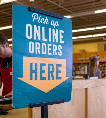 Sign for online grocery pickup in a store