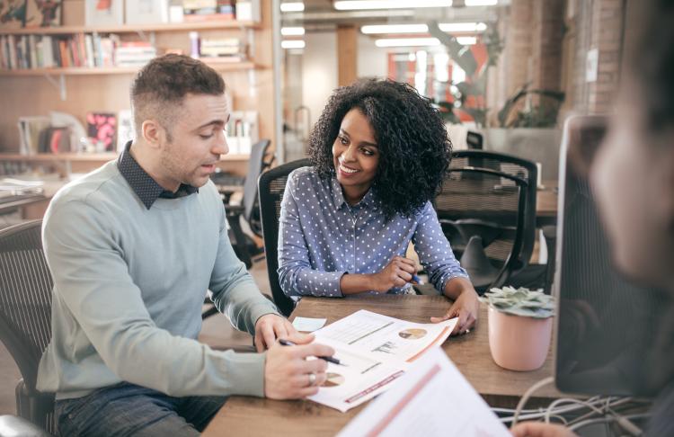 Wife and husband sit during an overview about their health benefits