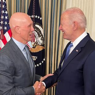 Matt Shay shakes hands with President Joe Biden at a White House bill signin