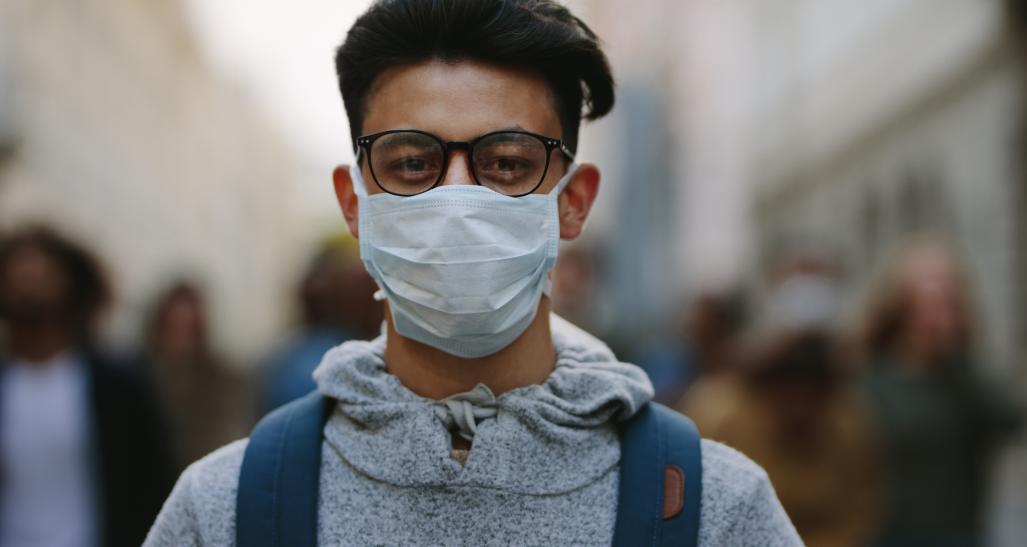 Man wearing a mask in crowd of protesters