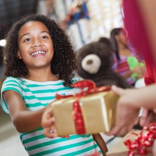 Child donates gift at gift drive