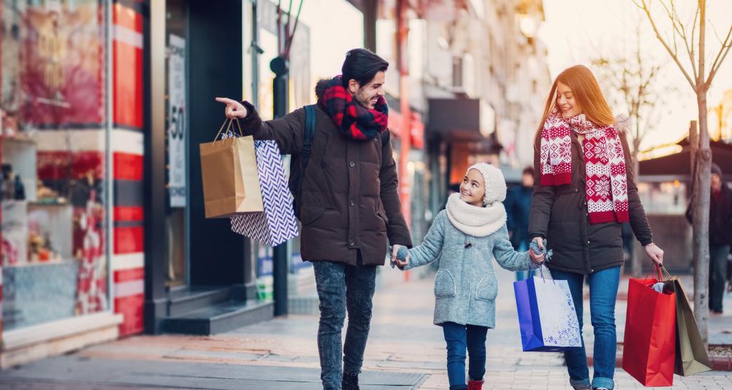 A couple and child shopping in winter