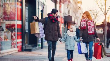 A couple and child shopping in winter