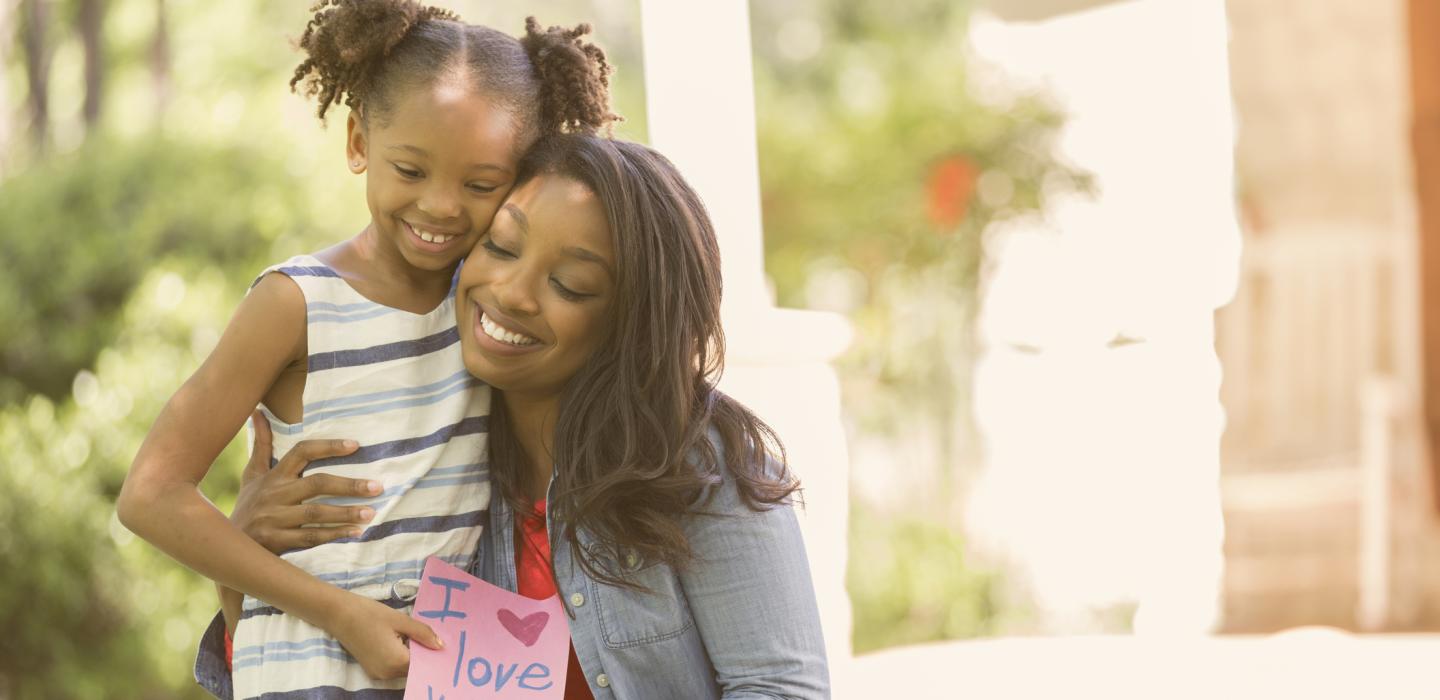 Mother and daughter with Mother's Day card