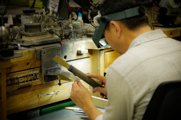 Individual making Jewelry for Dominion Jewelers.