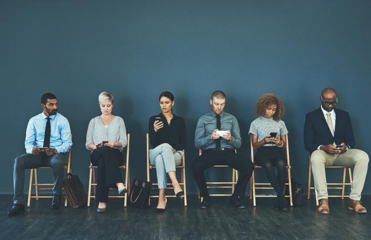 job seekers sitting in a room waiting for their interviews