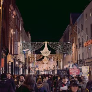 Hundreds of people shop at a busy outdoor mall during the holiday season