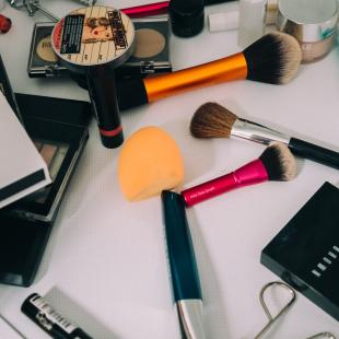 A flatlay of makeup tools and products