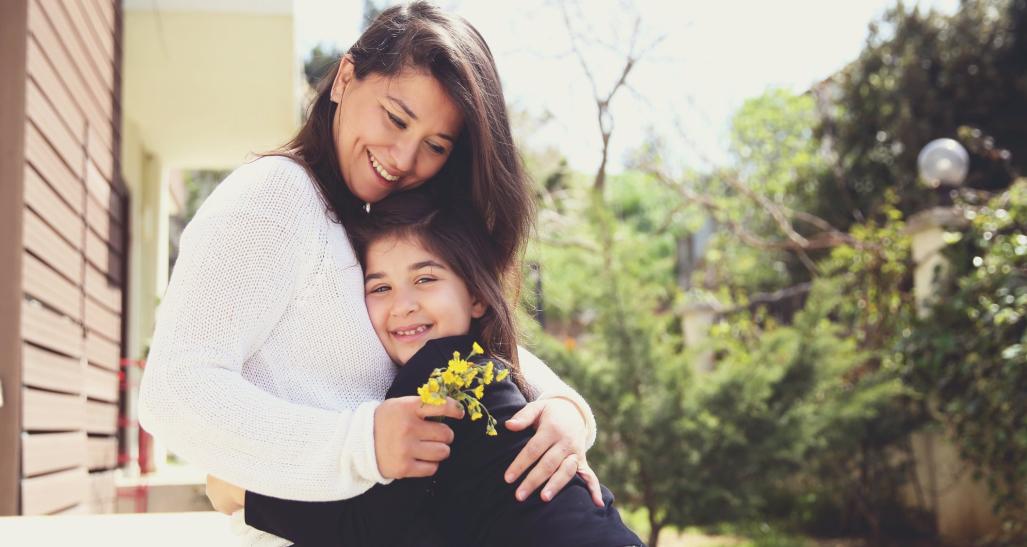 Child hugs mother