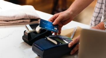 A customer swipes his credit card to purchase something at a store