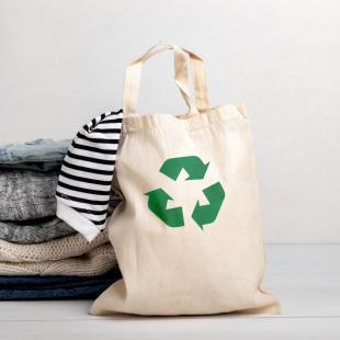 Reusable tote filled with garments.