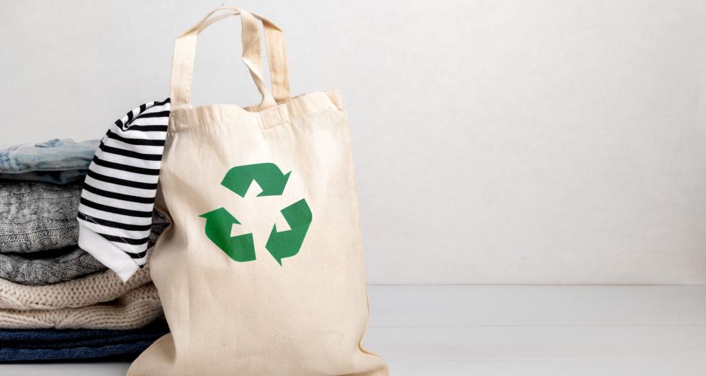 Reusable tote filled with garments.