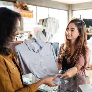 Woman returning clothes at a store.