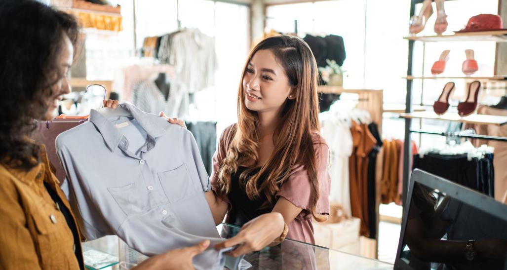 Woman returning clothes at a store.