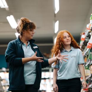 Two individuals working in retail.