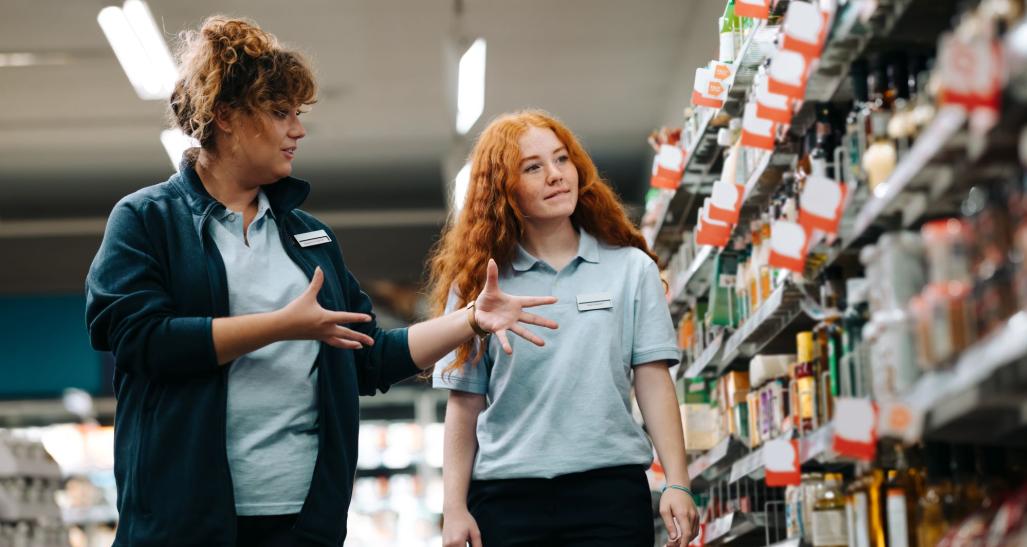 Two individuals working in retail.