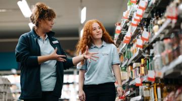 Two individuals working in retail.