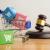 A shopping cart and gavel symbolizing retail law. 