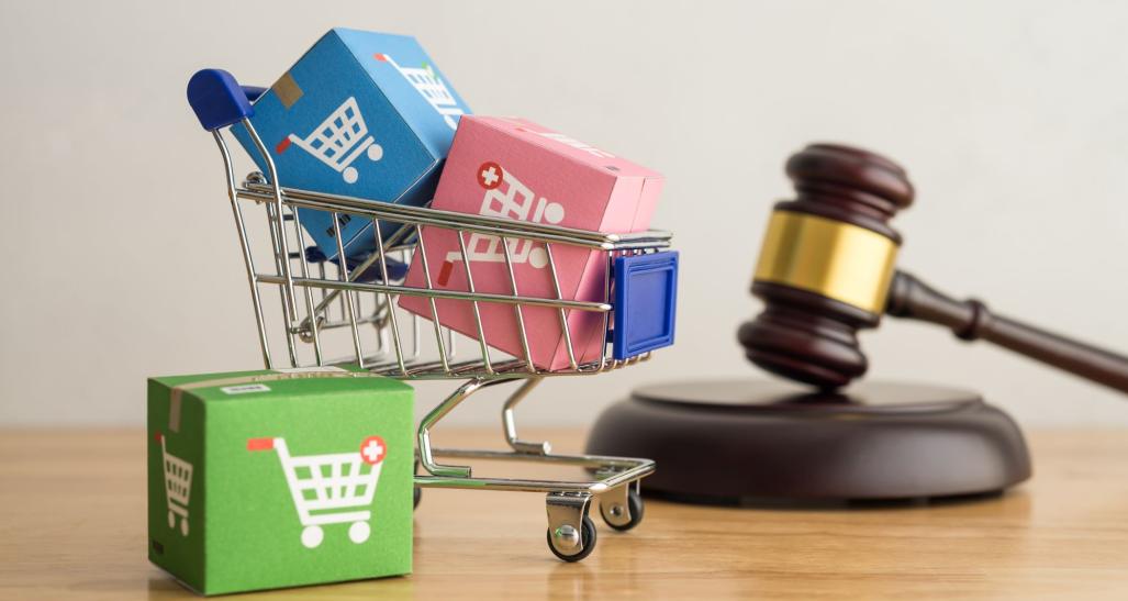 A shopping cart and gavel symbolizing retail law.