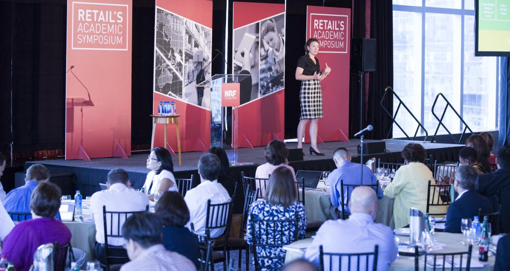 speaker is on stage at retail's academic symposium 2016 in NYC