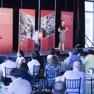 speaker is on stage at retail's academic symposium 2016 in NYC