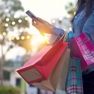 Individual using their cell phone while shopping. 