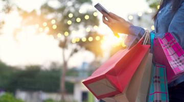 Individual using their cell phone while shopping. 