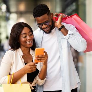 Individuals using a phone to shop.