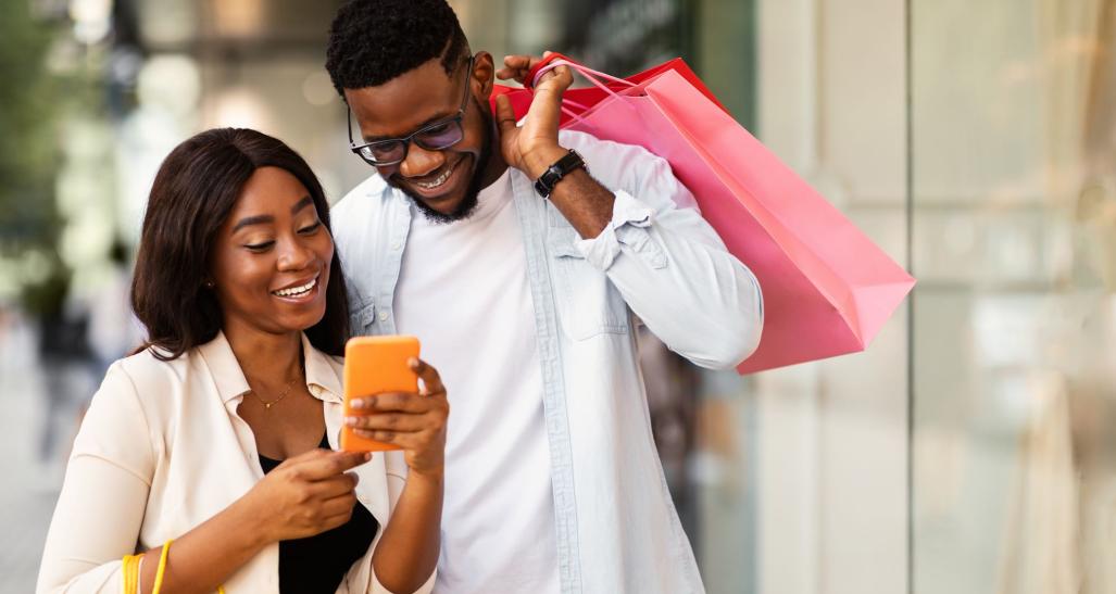 Individuals using a phone to shop.