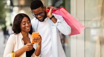 Individuals using a phone to shop.