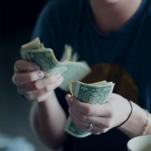 person flipping through cash