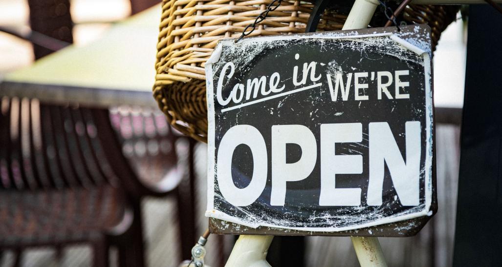 Store open sign in an outdoor cafe