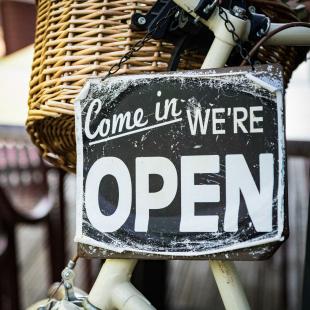 Store open sign in an outdoor cafe