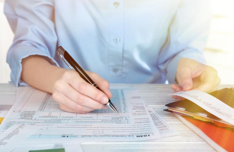 Man fills out his tax return forms
