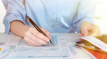 Man fills out his tax return forms