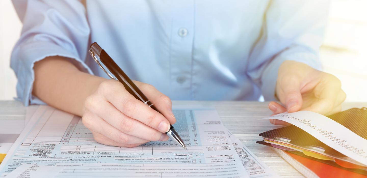 Man fills out his tax return forms