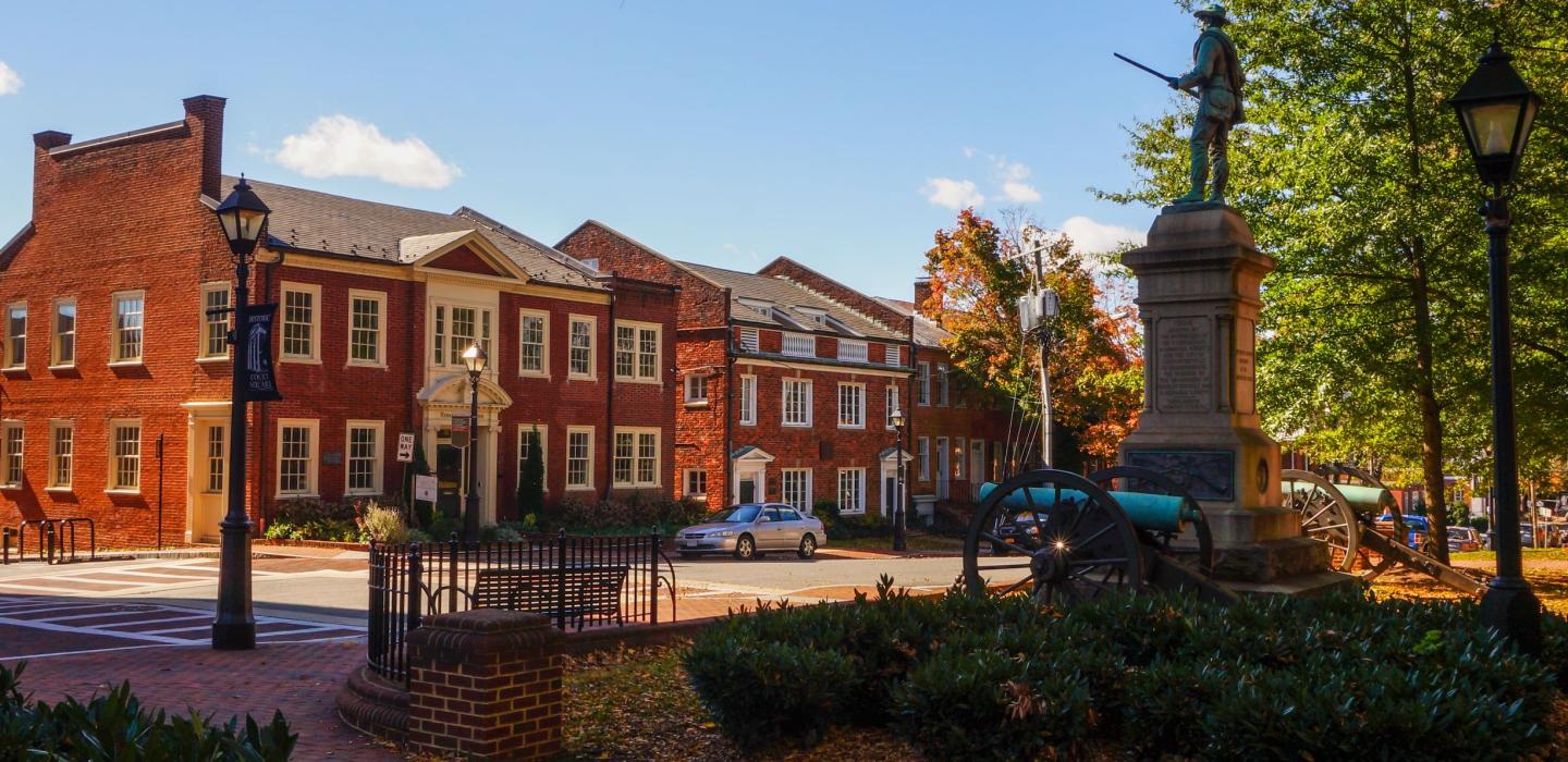 A historic statue and buildings located in Virginia.