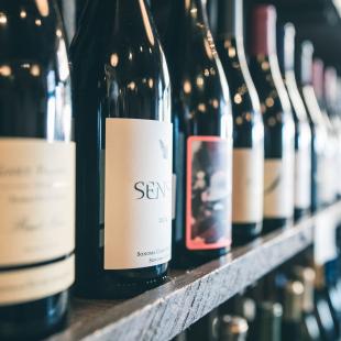 a closeup shot of various wine bottles in a wine cellar