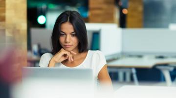 Woman works on computer in office