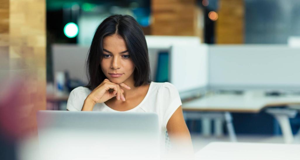 Woman works on computer in office