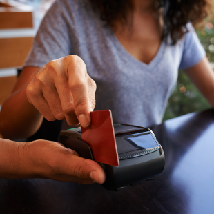credit card swipe to pay for a coffee shop purchase