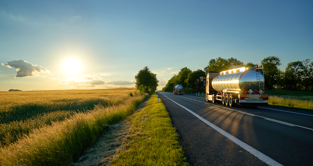 tanker trucks driving by cornfields