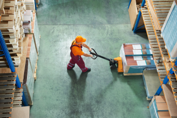 warehouse working moving a pallet of merchandise